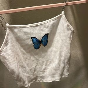 Crop top T-shirt with a blue butterfly on it the sleeves are made from chains.